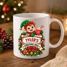 Personalised elf Christmas mug in glossy white ceramic with a name on a wooden sign